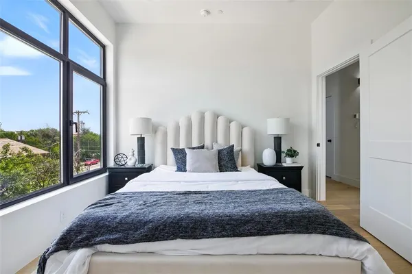 a bedroom with a large bed and a large window