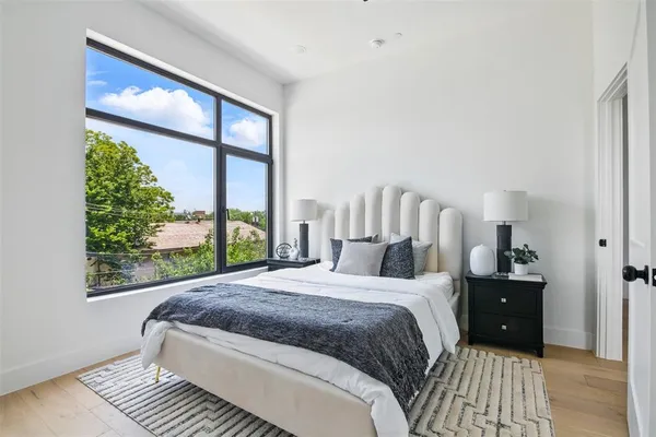 a bedroom with a large bed and a large window