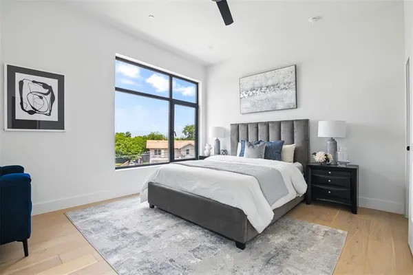 a bedroom with a large bed and a window