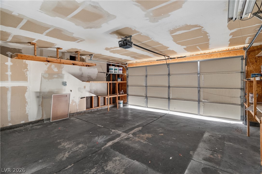 3156 Terrace View Drive Laughlin, NV 89029 - Photo 50 of 94 Functional garage space featuring integrated shelving and a smooth concrete floor.