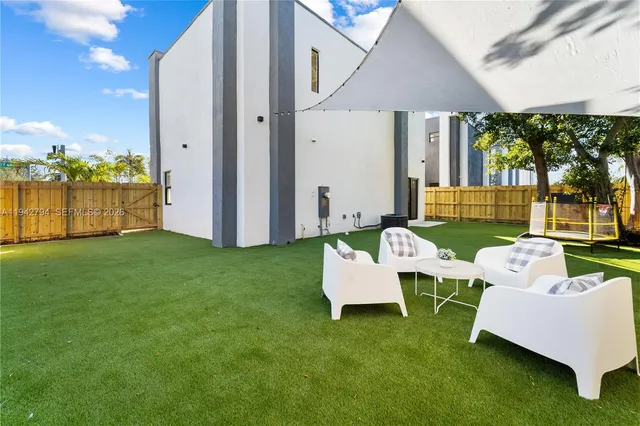 a view of an house with backyard and patio