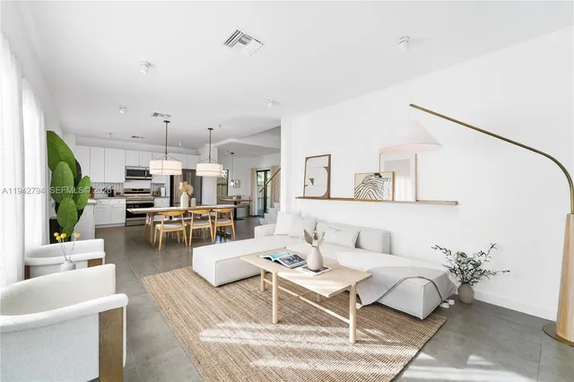a living room with furniture white walls and white walls