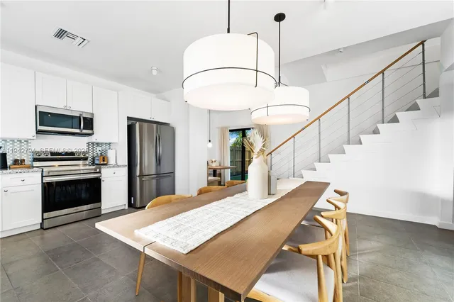 a kitchen with sink microwave and refrigerator