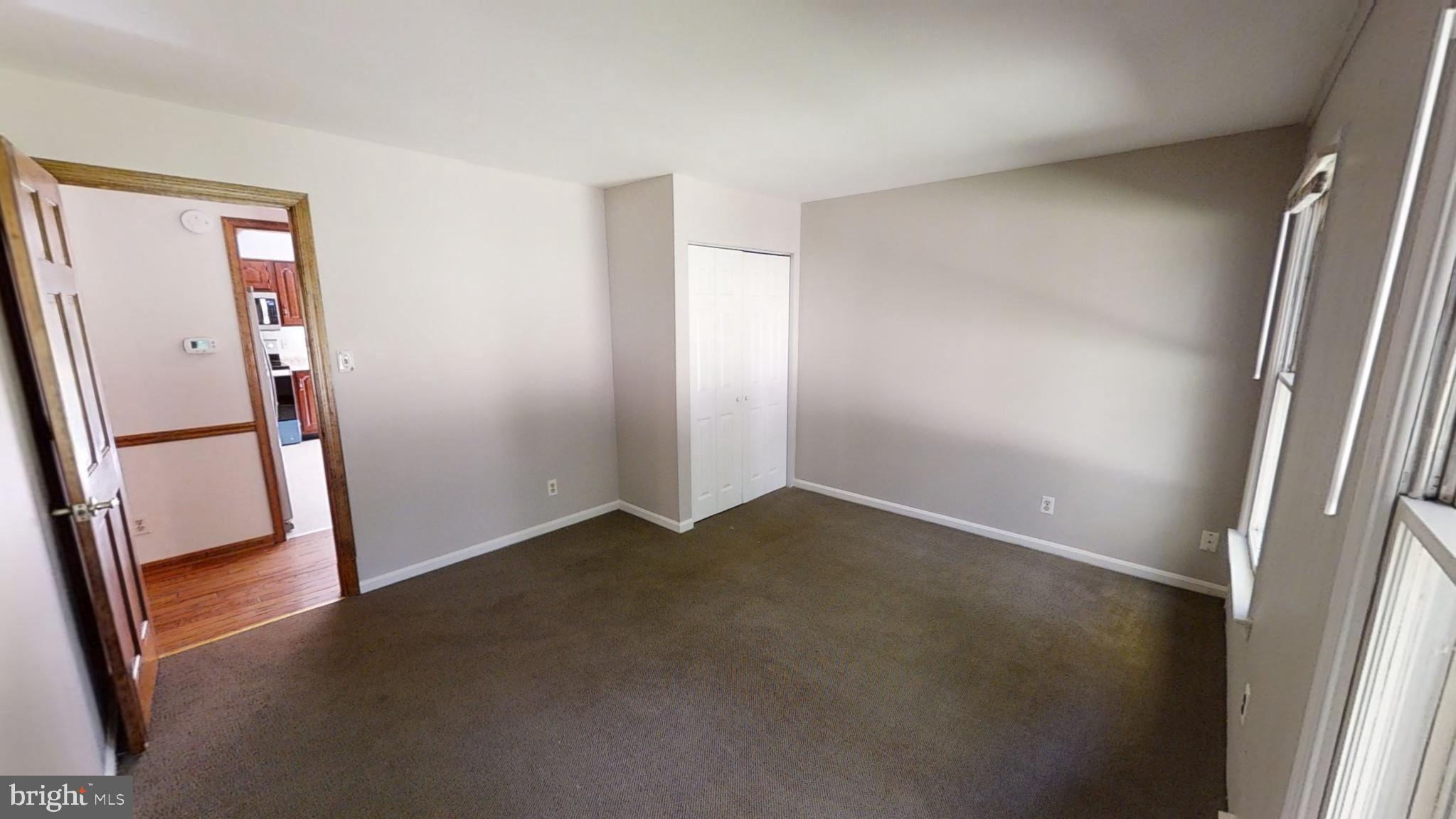 3842 Stoneybrook Road, Unit A White Plains, MD 20695 - Photo 14 of 33 an empty room with wooden floor and a window