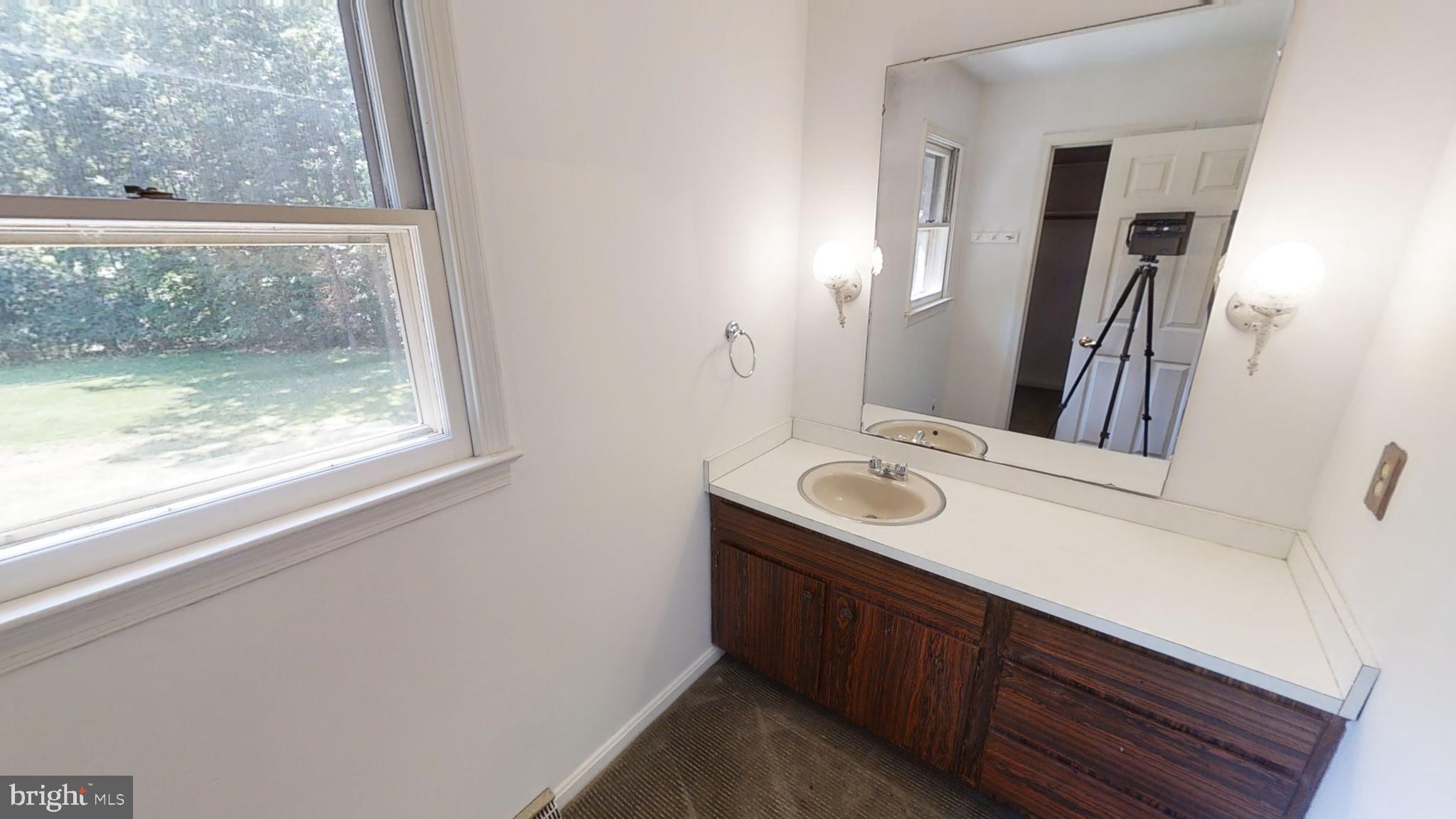 3842 Stoneybrook Road, Unit A White Plains, MD 20695 - Photo 21 of 33 a bathroom with a sink a mirror and a window