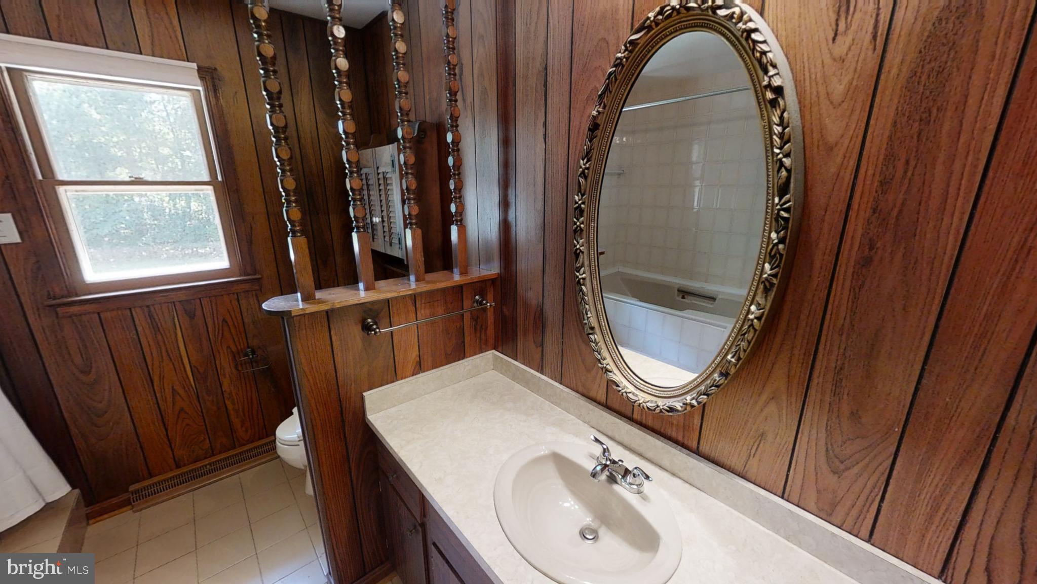3842 Stoneybrook Road, Unit A White Plains, MD 20695 - Photo 23 of 33 a bathroom with a sink a mirror and window