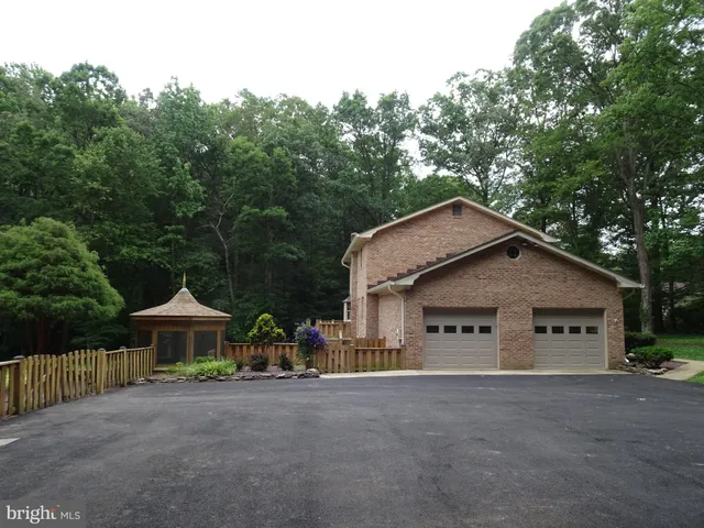 a aerial view of a house with a yard and sitting area