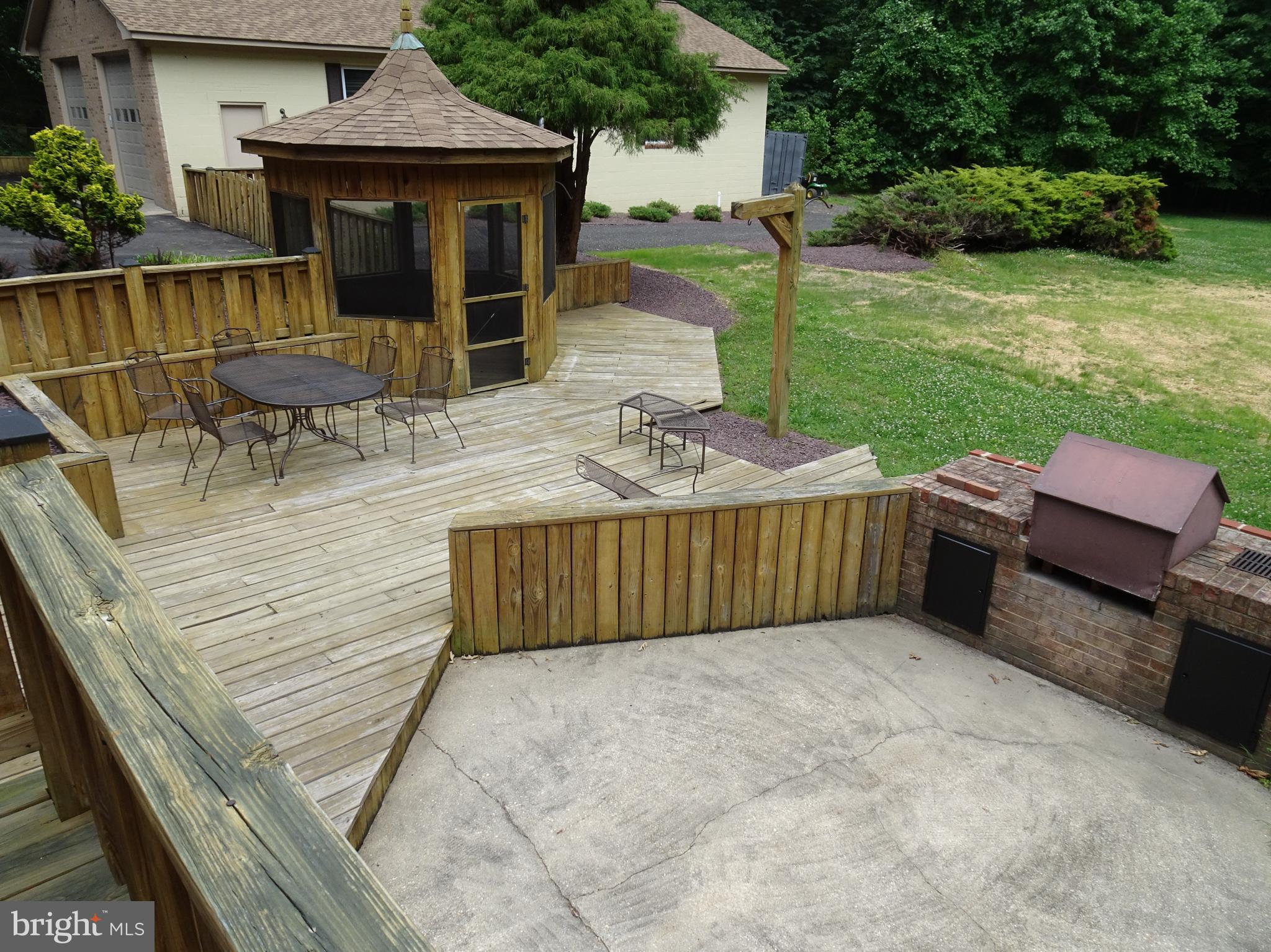3842 Stoneybrook Road, Unit A White Plains, MD 20695 - Photo 33 of 33 a view of a patio with table and chairs potted plants with wooden floor and fence