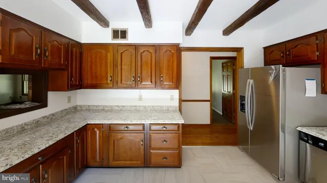 a kitchen with stainless steel appliances granite countertop a refrigerator and a sink