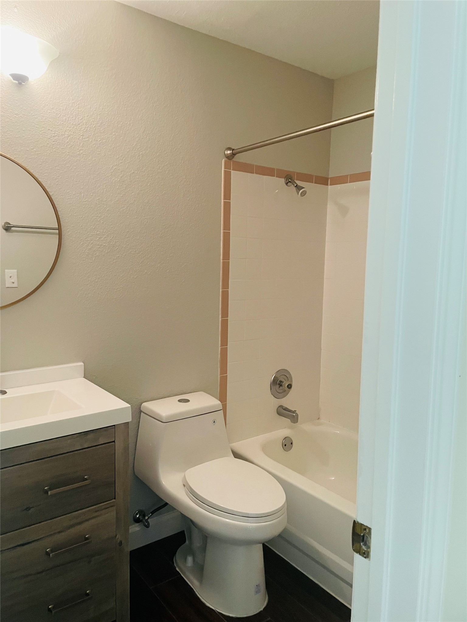 2406 Patsy Parkway Austin, TX 78744 - Photo 5 of 9 Bathroom featuring vanity, bathtub / shower combination, and a textured wall