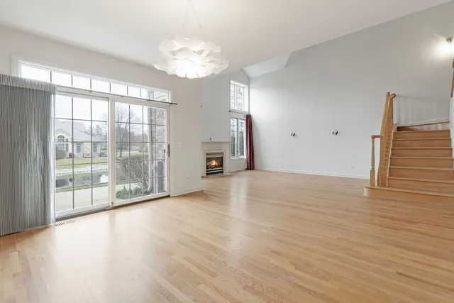 a view of a livingroom with wooden floor and a large window