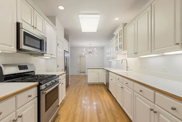 a kitchen with granite countertop cabinets stainless steel appliances and a sink