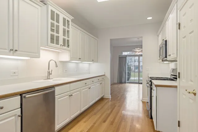 a kitchen with granite countertop a sink and cabinets