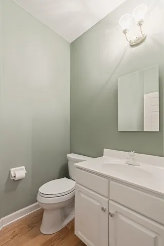 a bathroom with a toilet a sink and mirror