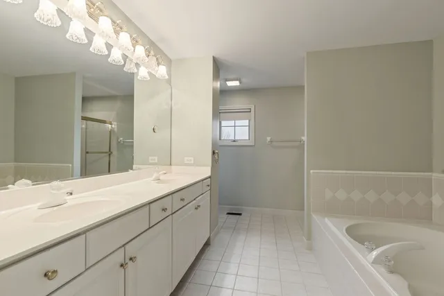a bathroom with a sink a large mirror and a bathtub