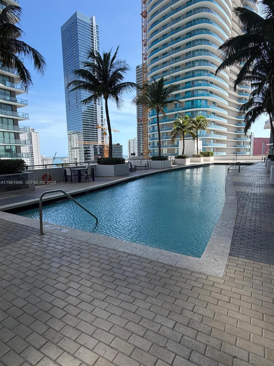 60 Southwest 13th Street, Unit 1107 Miami, FL 33130 - Photo 32 of 47 a view of a swimming pool with a chair