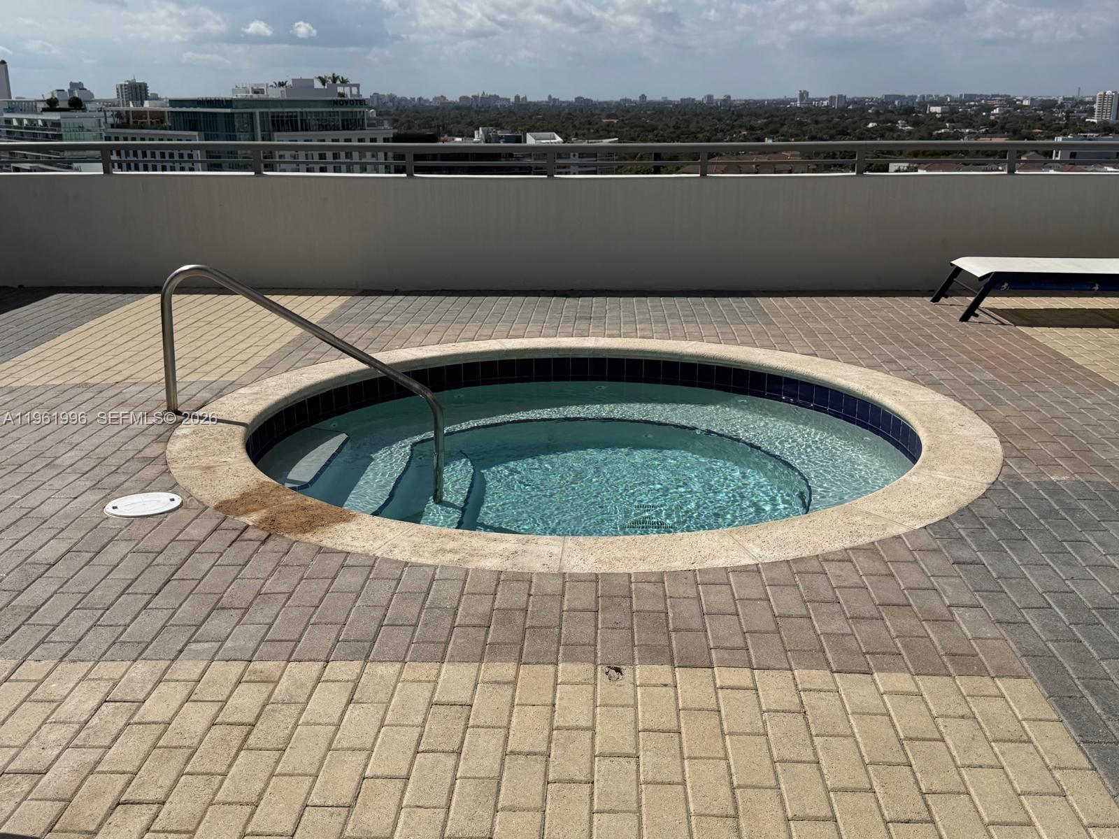 60 Southwest 13th Street, Unit 1107 Miami, FL 33130 - Photo 33 of 47 a view of a swimming pool with lake and houses in the back