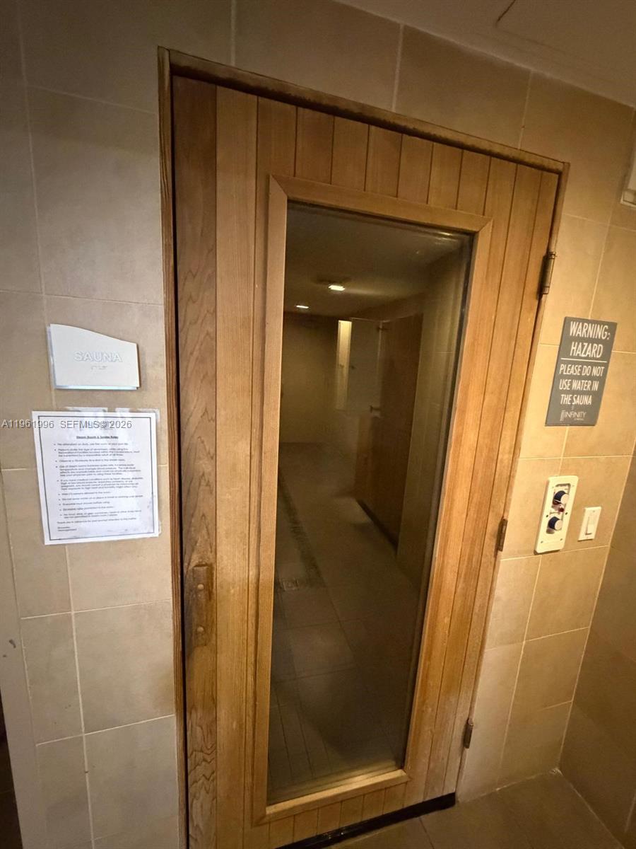 60 Southwest 13th Street, Unit 1107 Miami, FL 33130 - Photo 42 of 47 a bathroom with a glass door shower