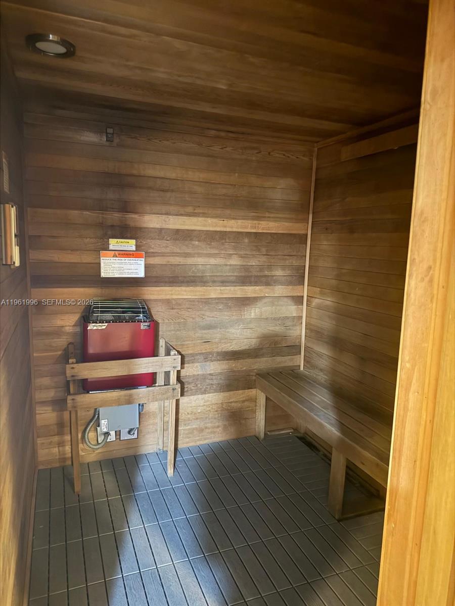 60 Southwest 13th Street, Unit 1107 Miami, FL 33130 - Photo 43 of 47 a hallway with a bench and wooden floor