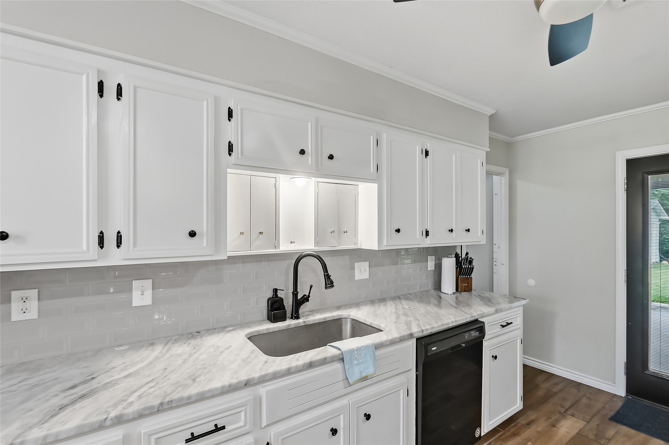 906 Standley Road Madisonville, TX 77864 - Photo 17 of 40 a view of a kitchen with white cabinets