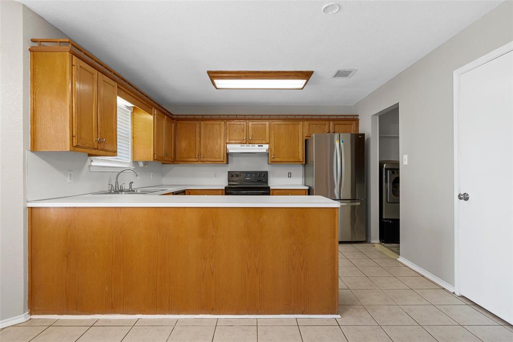 4609 Lexington Street Waco, TX 76705 - Photo 13 of 25 a view of kitchen with stainless steel appliances granite countertop a refrigerator a stove top oven a sink and dishwasher