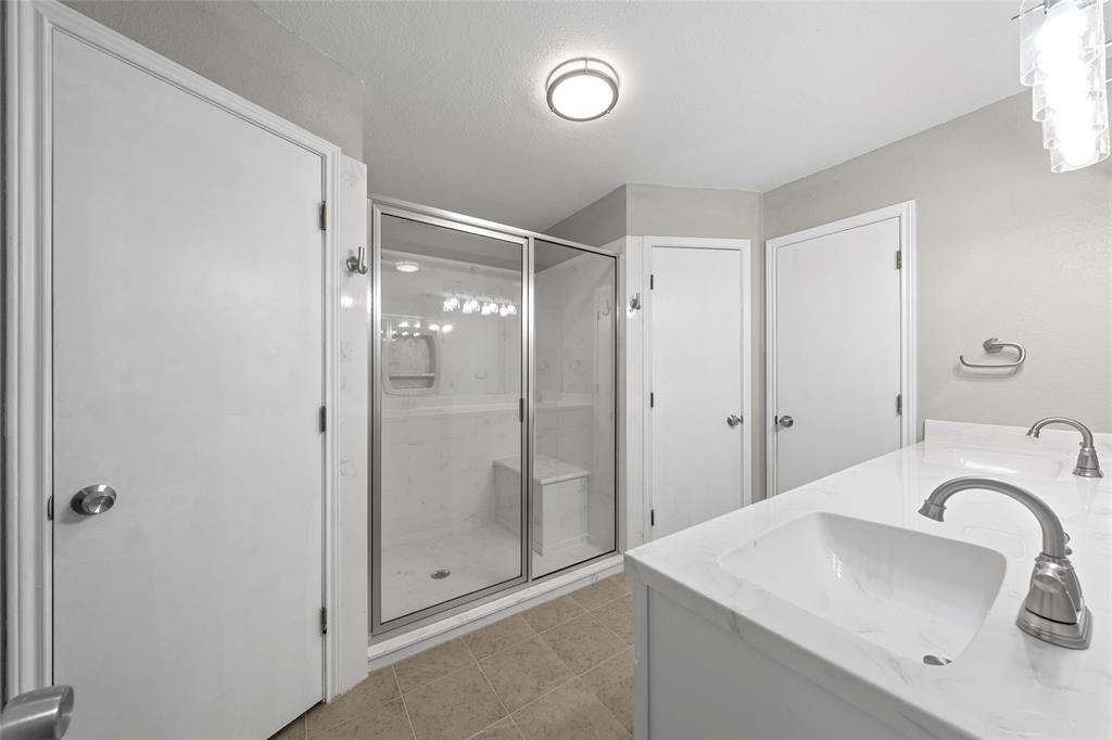4609 Lexington Street Waco, TX 76705 - Photo 18 of 25 a bathroom with a shower sink vanity and mirror