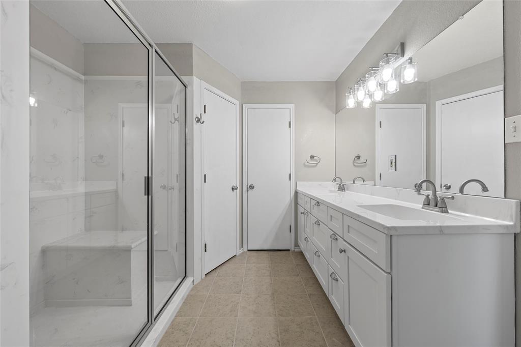 4609 Lexington Street Waco, TX 76705 - Photo 19 of 25 a bathroom with a double vanity sink and mirror
