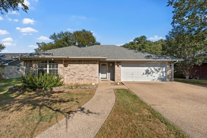 4609 Lexington Street Waco, TX 76705 - Photo 2 of 25 a front view of a house with a garden and yard