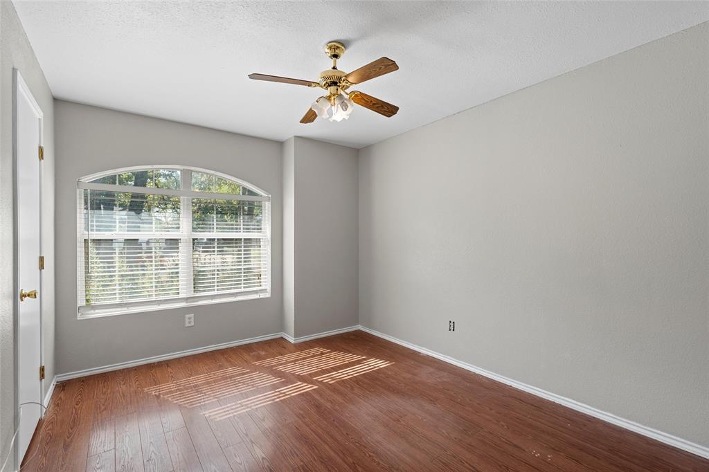 4609 Lexington Street Waco, TX 76705 - Photo 24 of 25 an empty room with wooden floor fan and windows