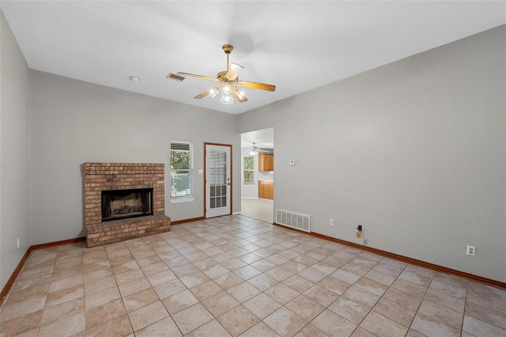 4609 Lexington Street Waco, TX 76705 - Photo 9 of 25 an empty room with windows and fireplace