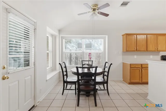 a view of a dining room with furniture and a window