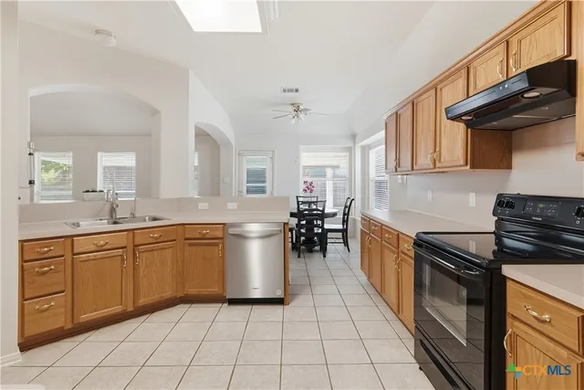 a kitchen with stainless steel appliances granite countertop a sink and cabinets