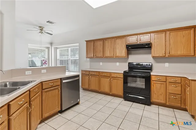 a kitchen with stainless steel appliances granite countertop a sink and cabinets