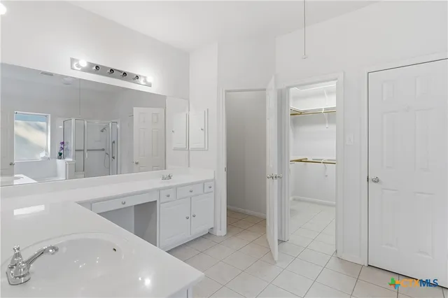 a spacious bathroom with a tub shower and sink