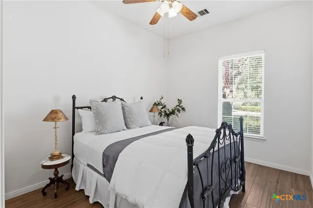 a bedroom with a bed and a table