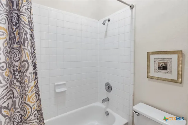 a bathroom with a bathtub and shower