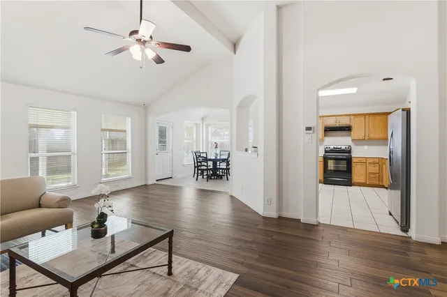 a living room with furniture and wooden floor