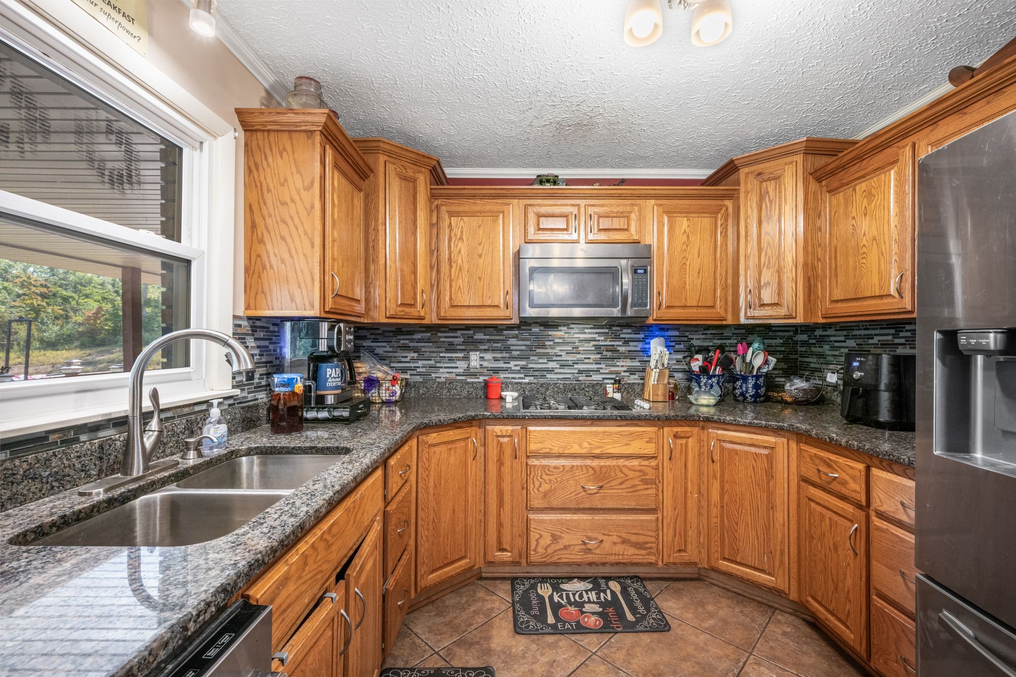 298 Langford Road Waverly, TN 37185 - Photo 11 of 53 a kitchen with stainless steel appliances granite countertop a sink a stove and cabinets