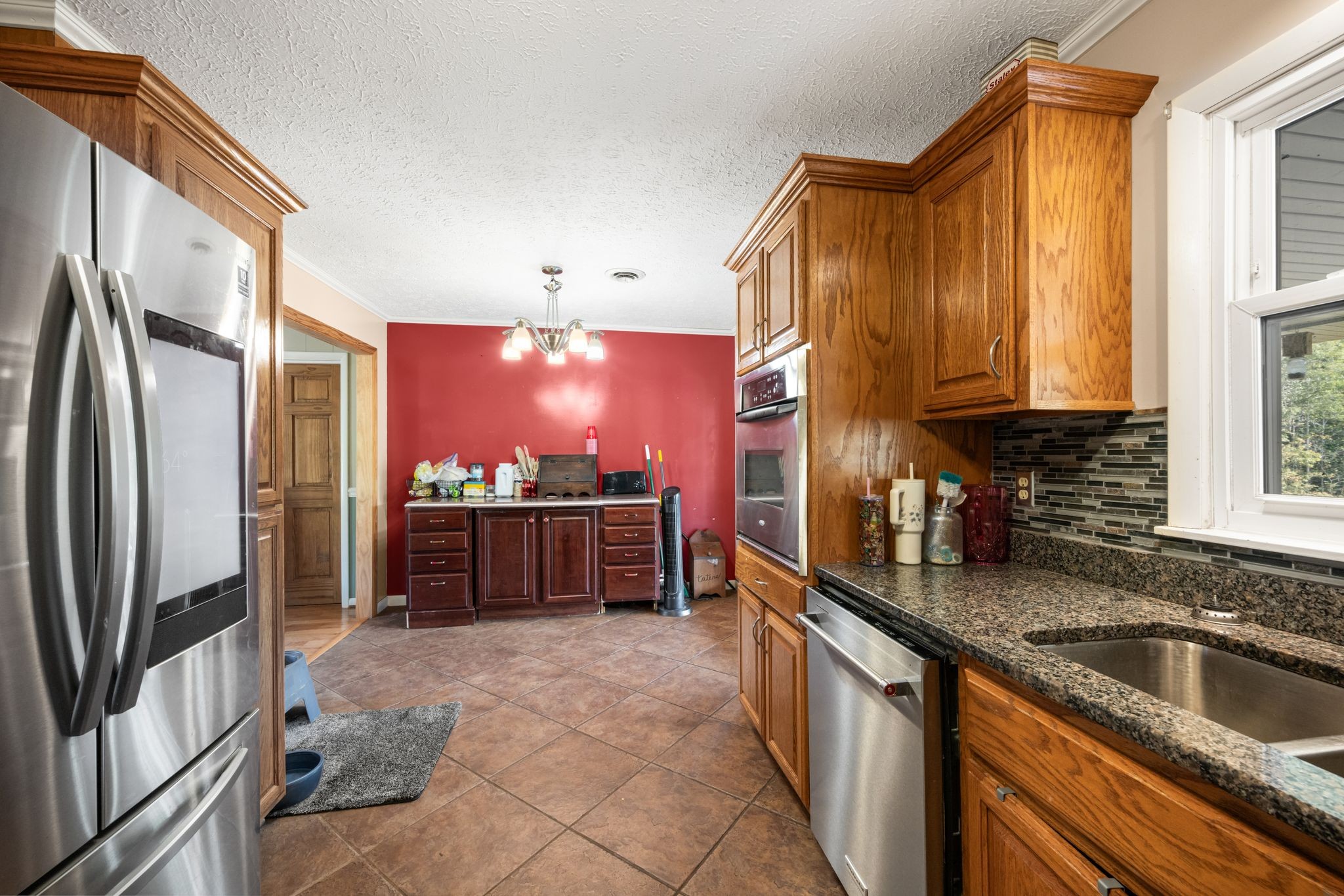 298 Langford Road Waverly, TN 37185 - Photo 13 of 53 a kitchen with stainless steel appliances a sink stove and refrigerator