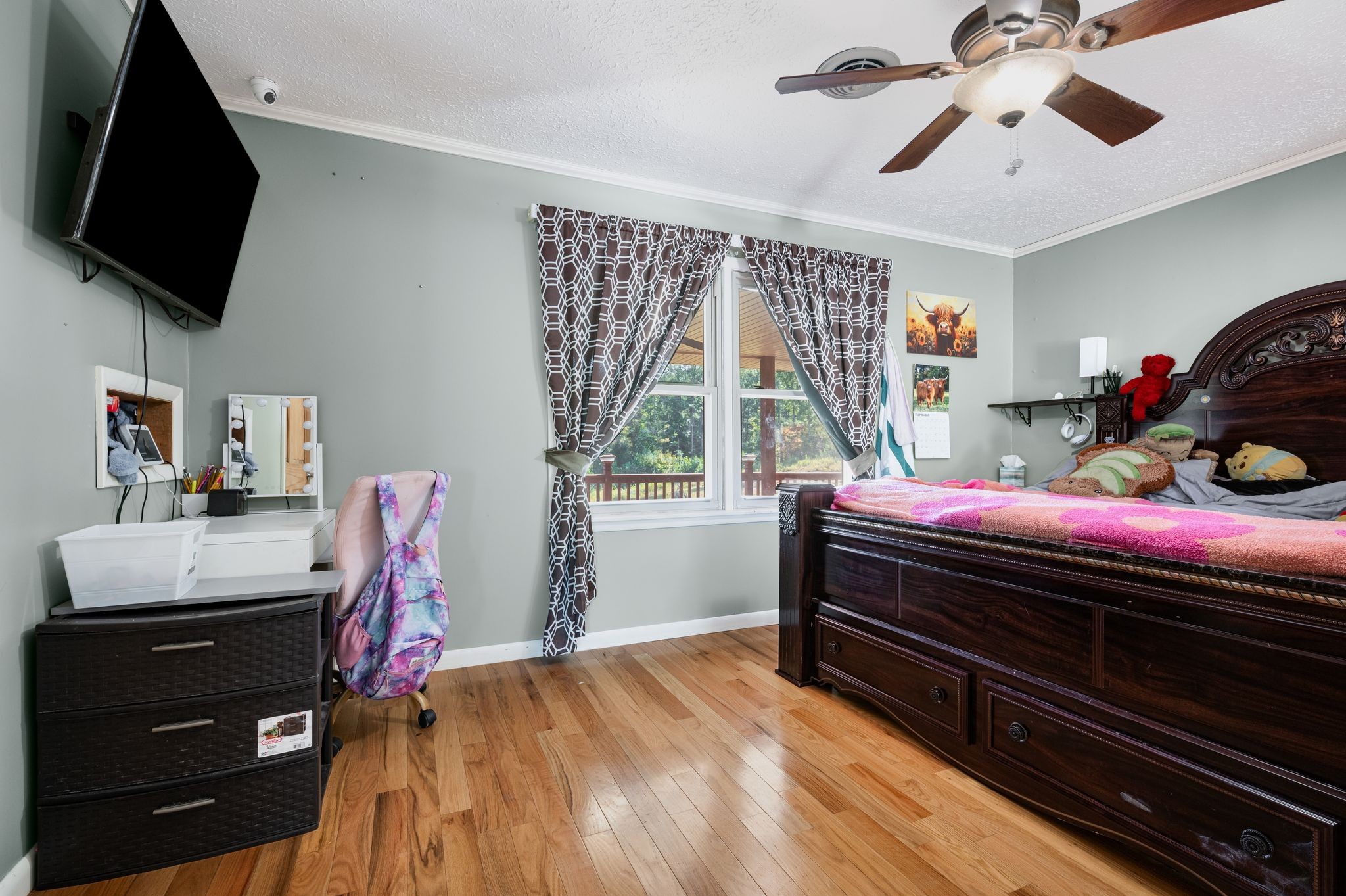 298 Langford Road Waverly, TN 37185 - Photo 15 of 53 a bedroom with a bed window and a flat screen tv