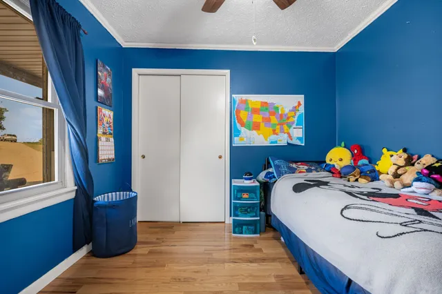 a bedroom with furniture and a window