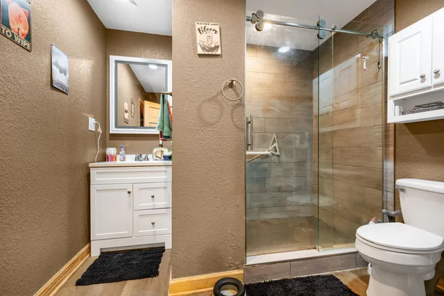 a bathroom with a sink a toilet and shower