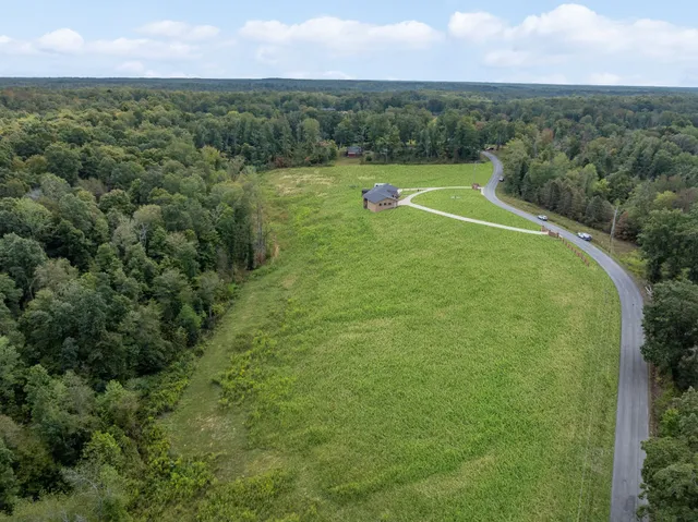 a view of a green yard with a lake