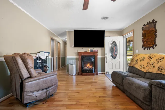 a living room with furniture a flat screen tv and a fireplace
