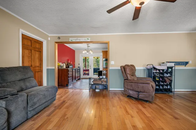 a living room with furniture and a wooden floor