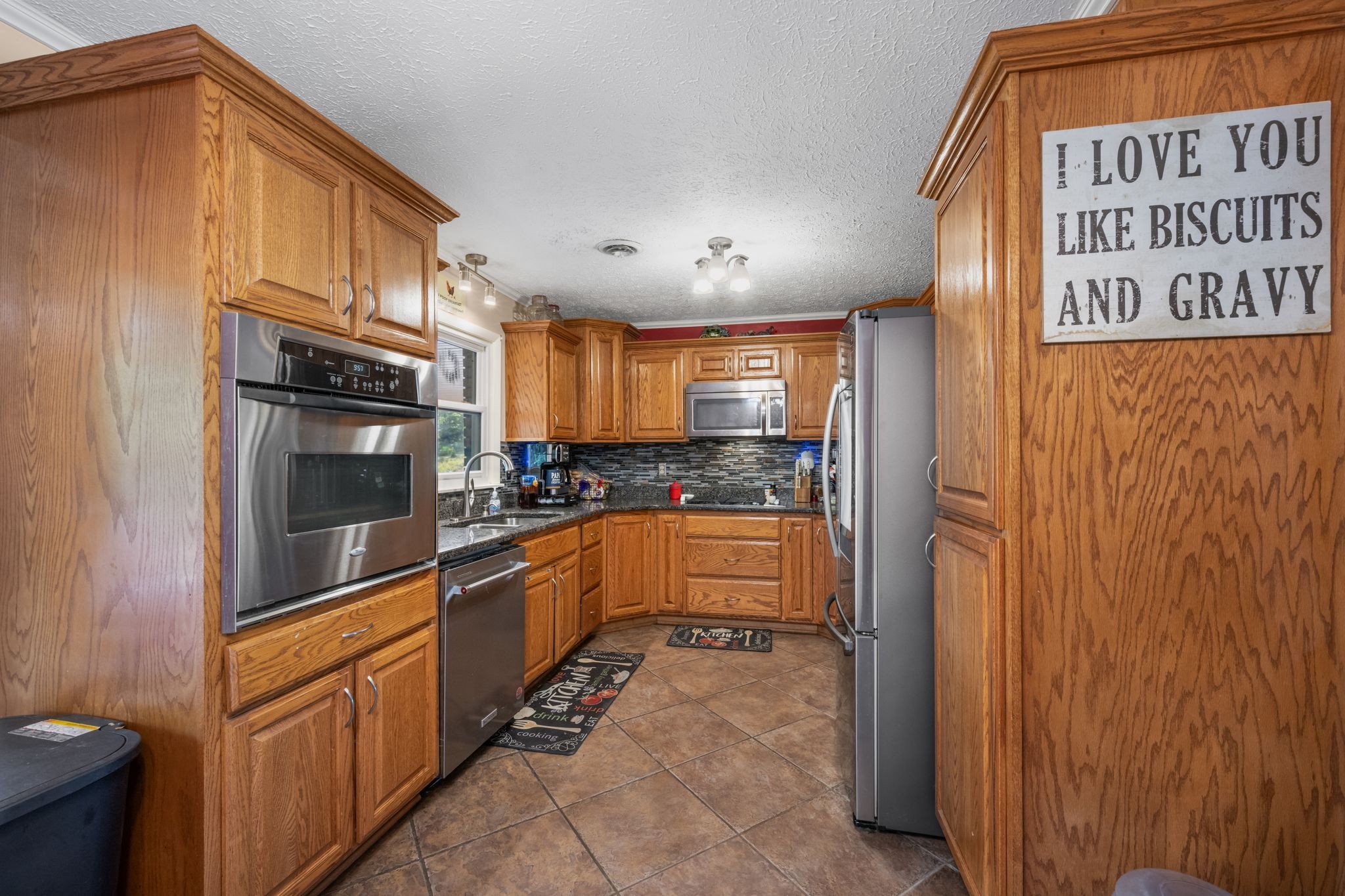 298 Langford Road Waverly, TN 37185 - Photo 10 of 53 a kitchen with stainless steel appliances granite countertop a refrigerator and a sink