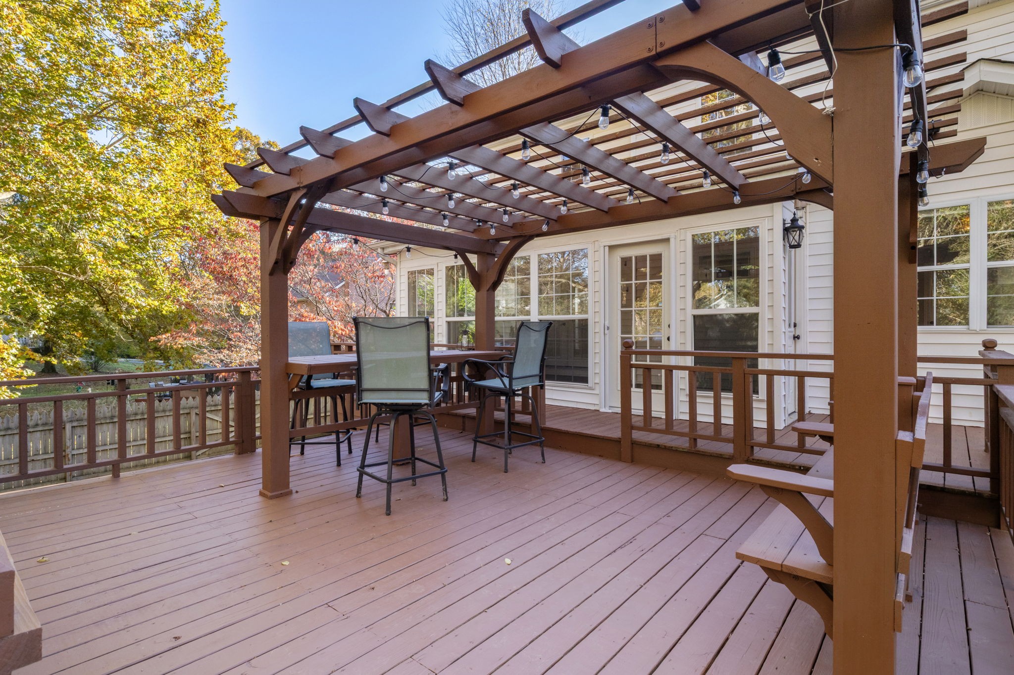 a view of a patio with table and chairs and wooden floor