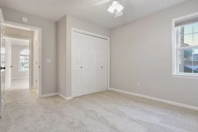 a bathroom with a granite countertop sink toilet a mirror and shower