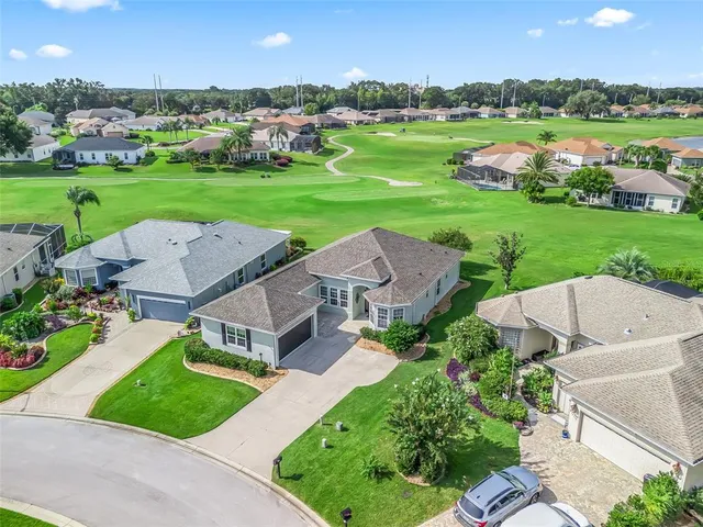 an aerial view of a house with big yard