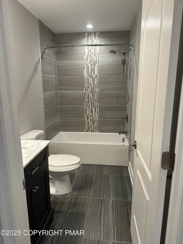 a bathroom with a bathtub and a toilet